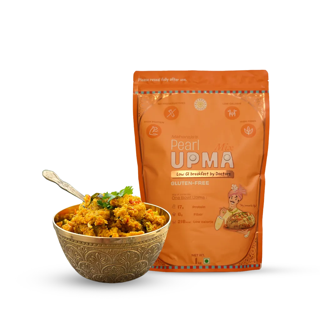 An orange stand-up pouch of Pearl UPMA gluten free breakfast mix displayed next to a decorative gold-toned bowl filled with cooked upma and garnished with cilantro, on a clean white background.
